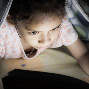 bigstock-A-Girl-Reading-On-The-Bed-100482716