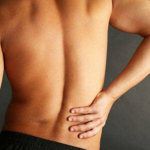 bigstock-Young-man-with-back-pain-on-gr-52560715