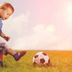 bigstock-Sports-kid-Boy-playing-footba-77211935