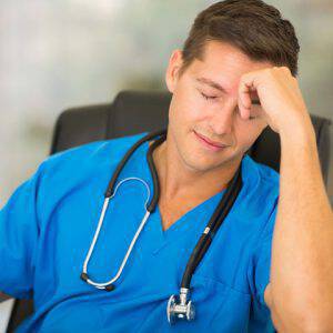 bigstock-tired-medical-worker-sitting-i-95895779