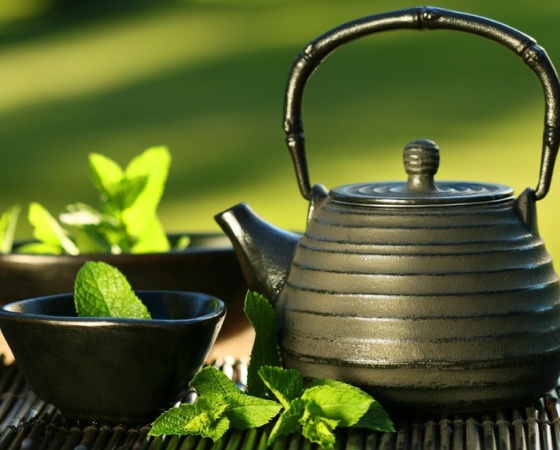 Black asian teapot with mint tea